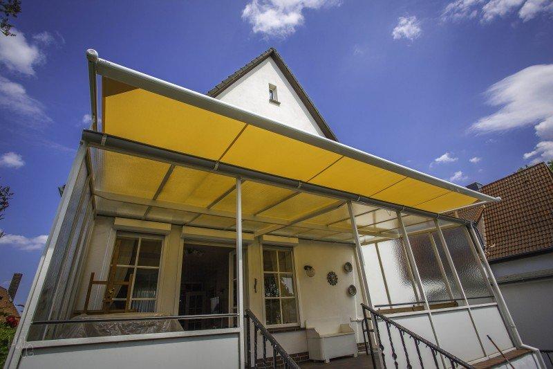 Markise in gelb über Glasüberdachung